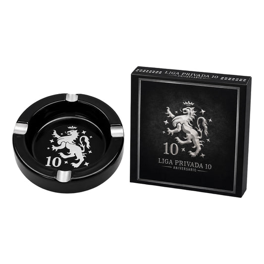 Black ashtray with silver lion design and matching box on a white background