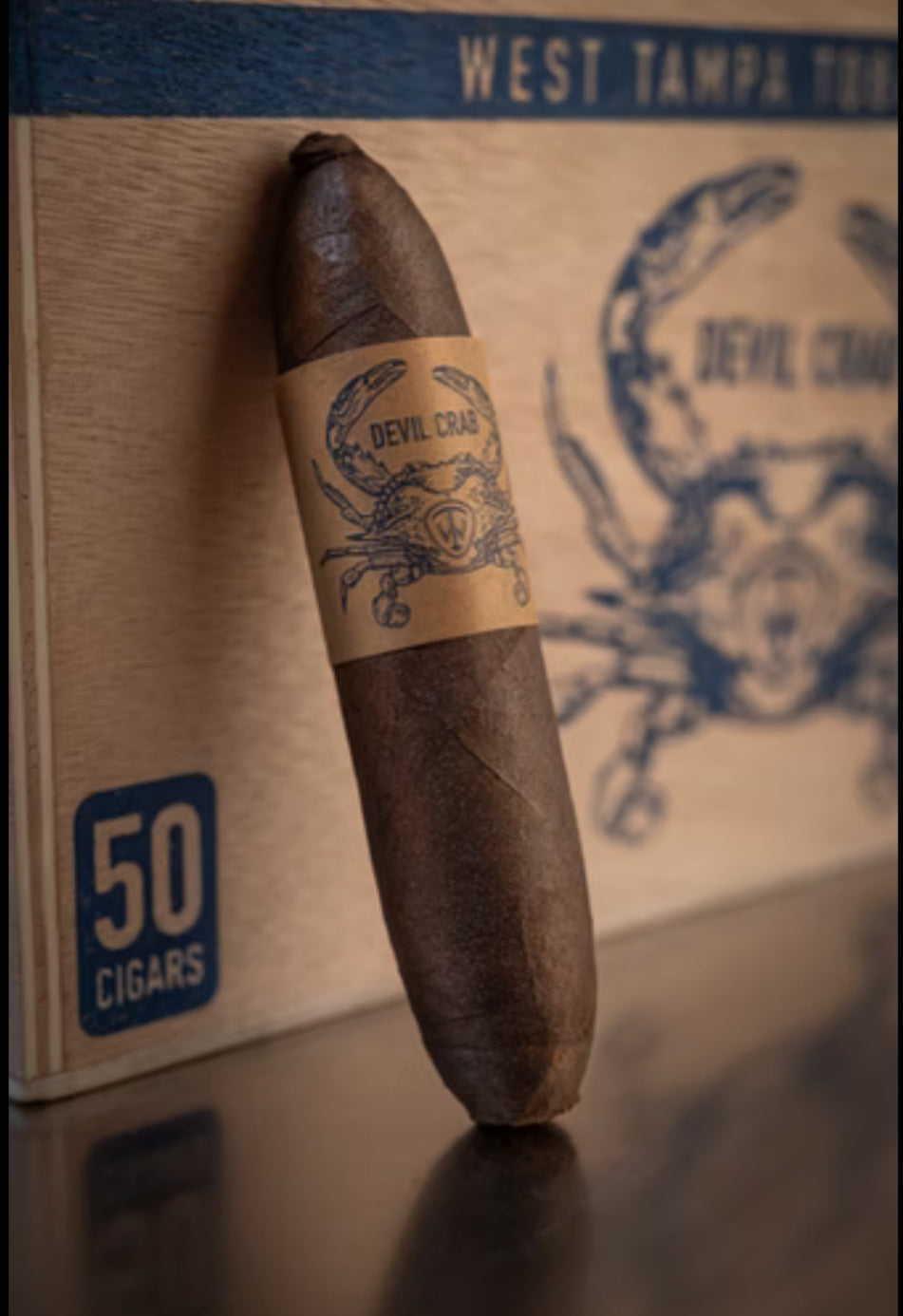 Cigar with a label on a box labeled '50 Cigars' featuring a scorpion design.